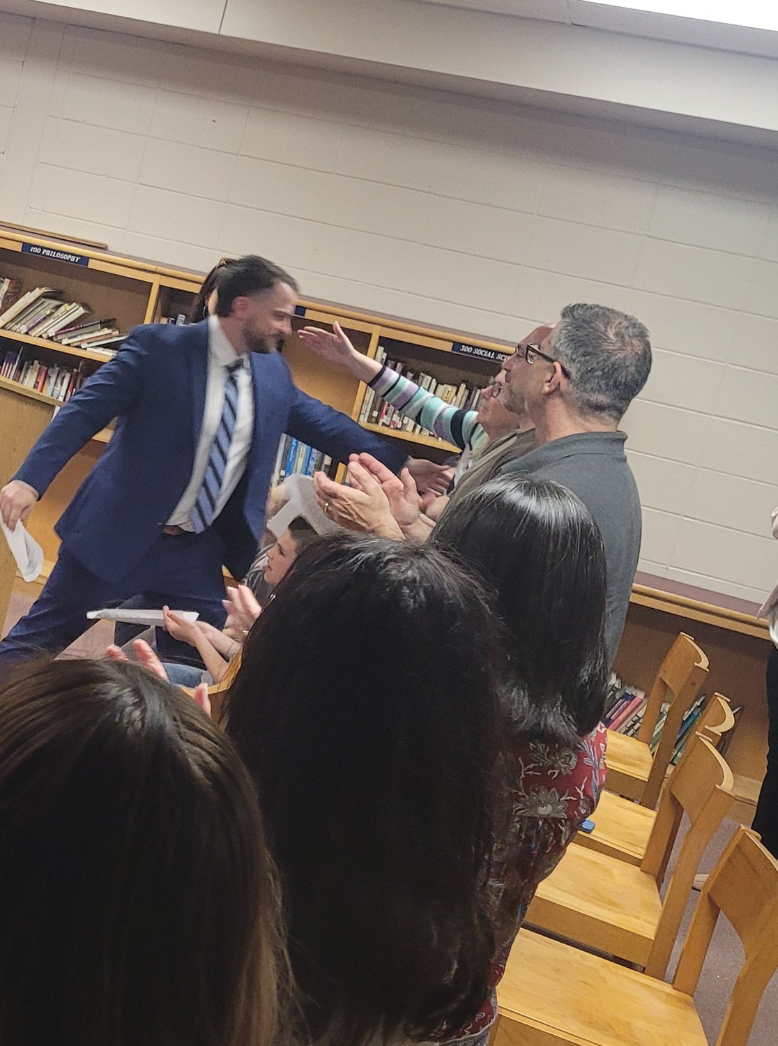 HUGS ALL AROUND: Matt Velino, the now former assistant principal at Johnston Senior High School has been promoted to the school’s top administrator post — the Principal.